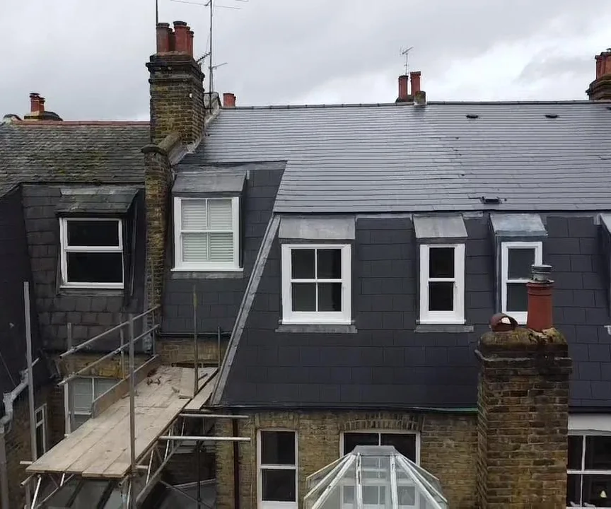 Slate re-roof on a Victorian terrace with repointed chimney stacks, new lead flashings and dormers