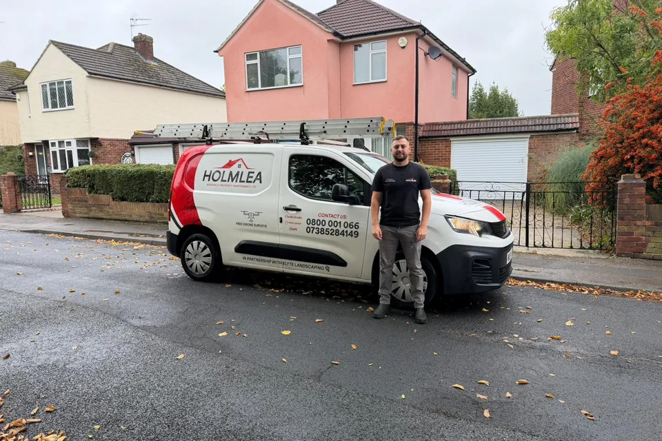 Jack Peters of Holmlea Roofing standing beside the company van