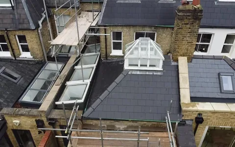 New slate roof with a dormer and two Velux windows on a rear extension, seen from above