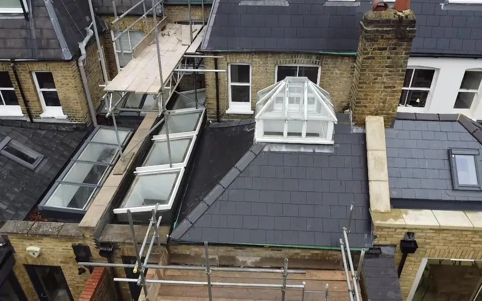 New slate roof with a dormer and two Velux windows on a rear extension, seen from above