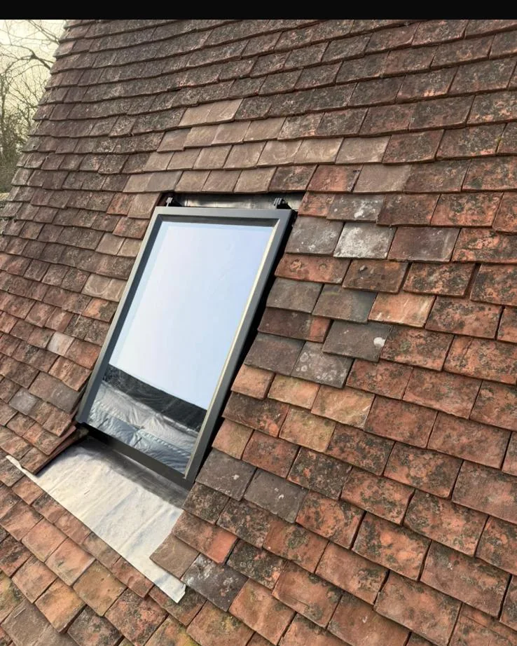 Velux roof window set into an old clay tile roof